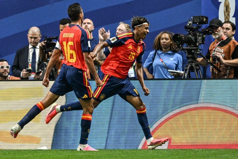 TOPSHOT - Spain's forward #19 Lamine Yamal (R) celebrates after scoring the opening goal during the 2026 World Cup Group H football match between Spain and Saudi Arabia at the Atlanta Stadium in Atlanta on June 21, 2026.