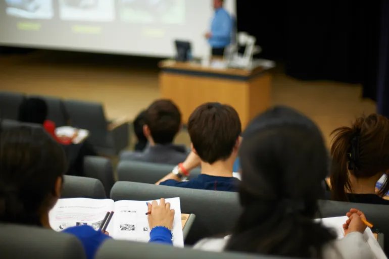 Students reading book in class