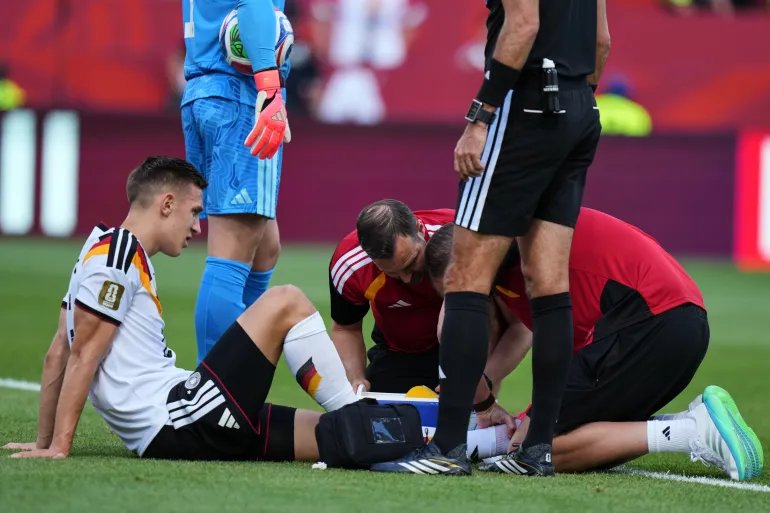 Germany's Nico Schlotterbeck receives treatment following an injury during the World Cup Group E soccer match between Germany and Ivory Coast in Toronto, Saturday, June 20, 2026. (AP Photo/Stephanie Scarbrough)
